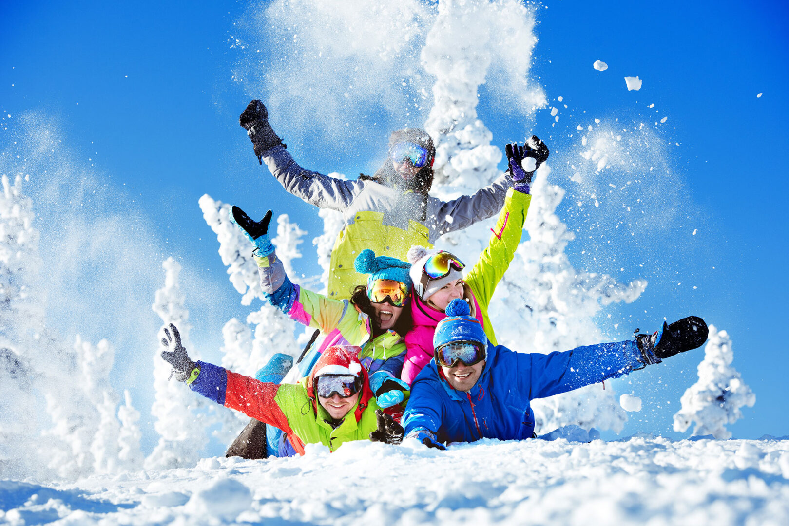 Group happy friends having fun at a ski resort. Skiers and snowboarders team.