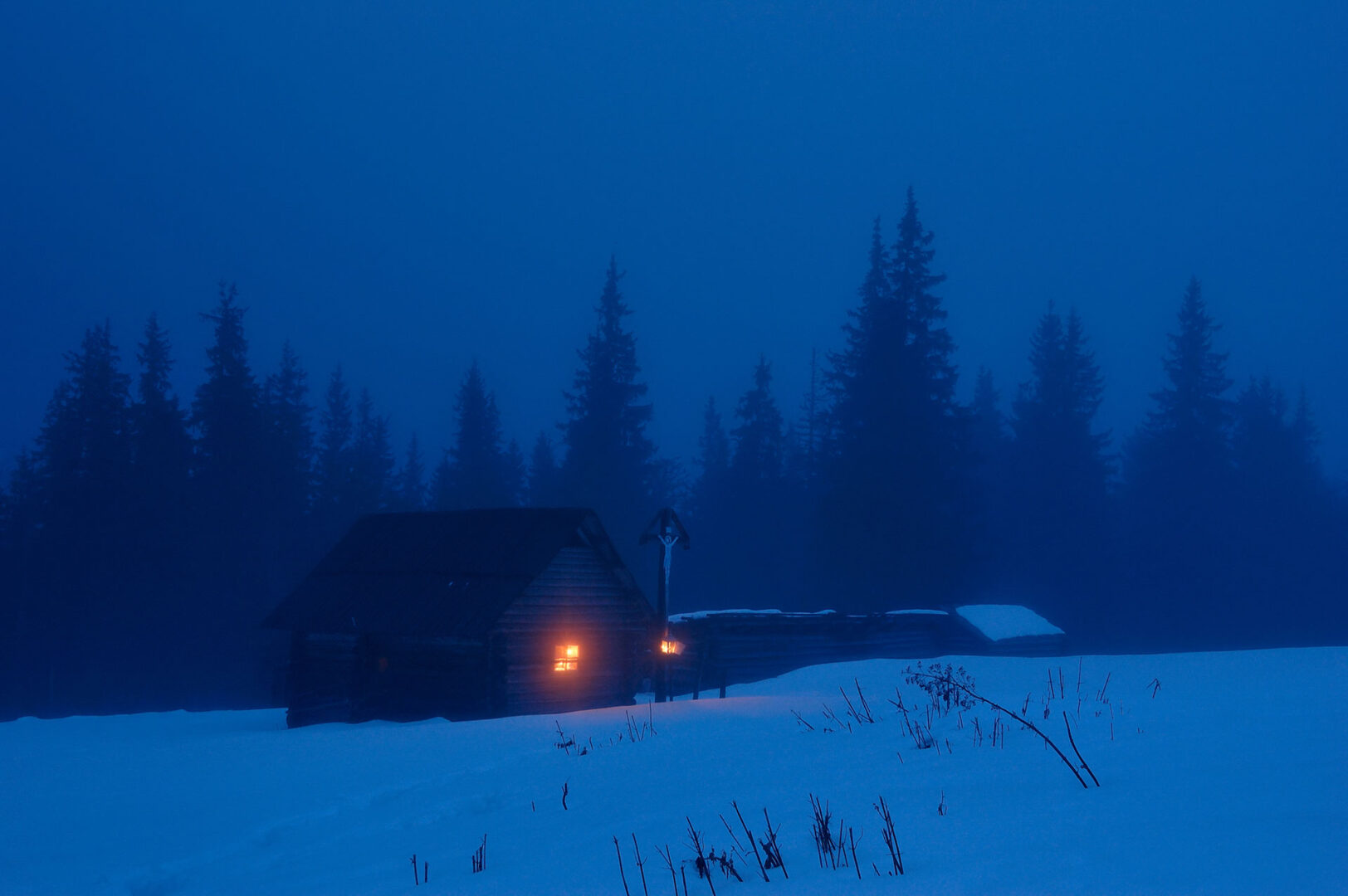 High-mountainous small house on a winter evening.