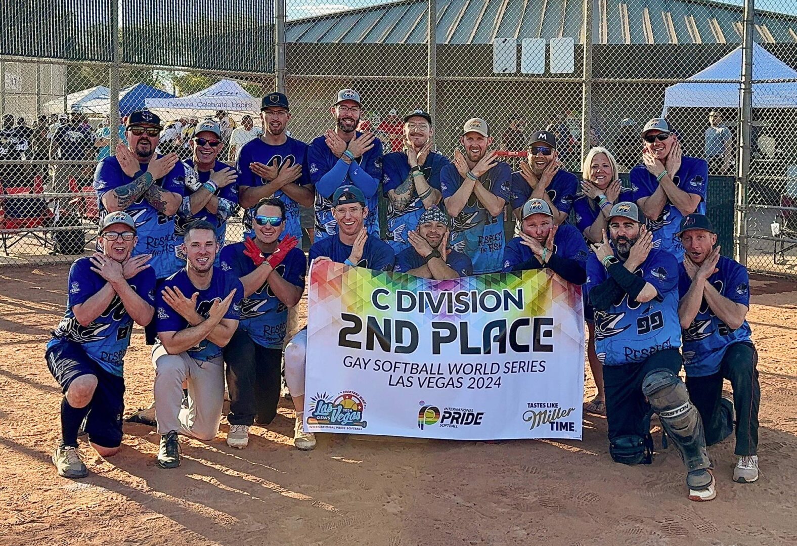 Members of the MN Muskies holding a 2nd Place banner at The Gay Softball World Series.