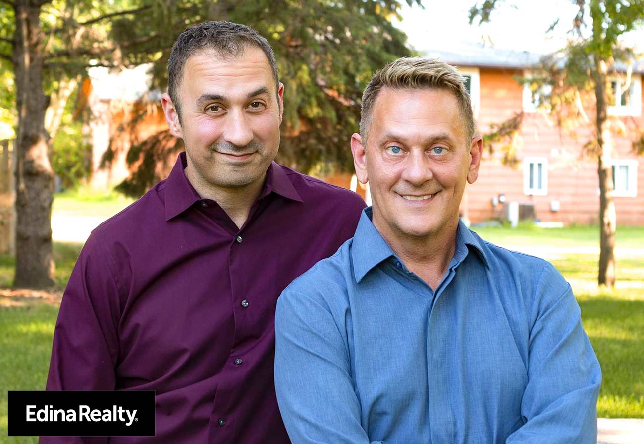 IMG_0592 Professional headshot of realtors Greg Storlie and Chris Hentges.