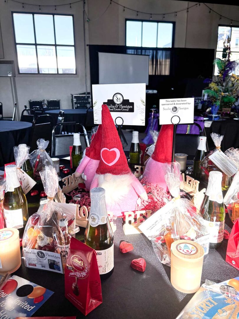 Sponsorship table with fun and festive gnomes, candles, beer and chocolate.