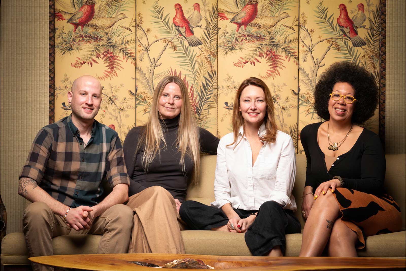 A team of three woman and one man sitting on a couch at the store called JANE.