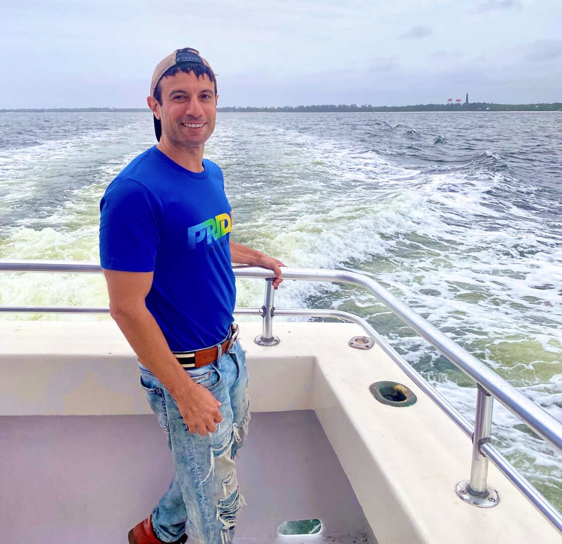 Joey Amato on a boat for a Frisky Mermaid Dolphin Cruise.