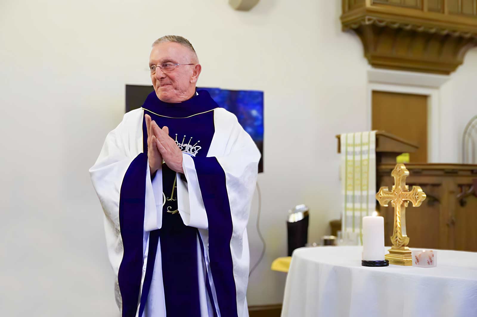 Rev. Harry Hartigan standing in his church.