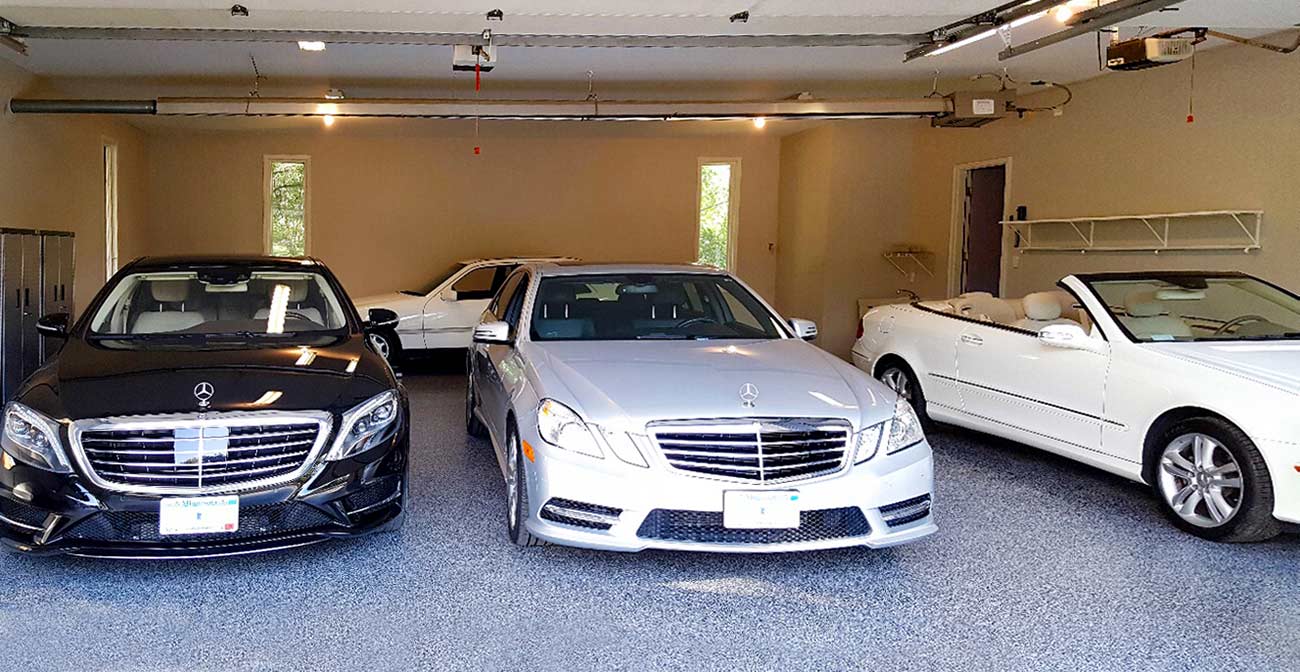 Cars in a garage with treated flooring.