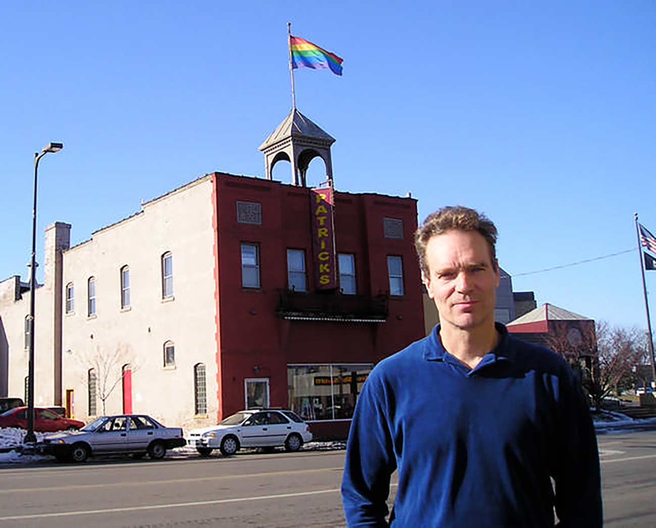 A younger Patrick Scully in front of a gay bar.