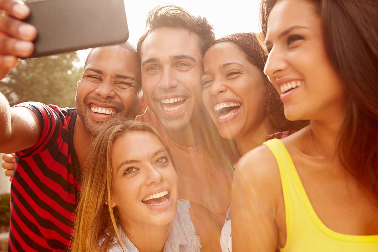 Save Download Preview Group Of Friends On Holiday Taking Selfie With Mobile Phone