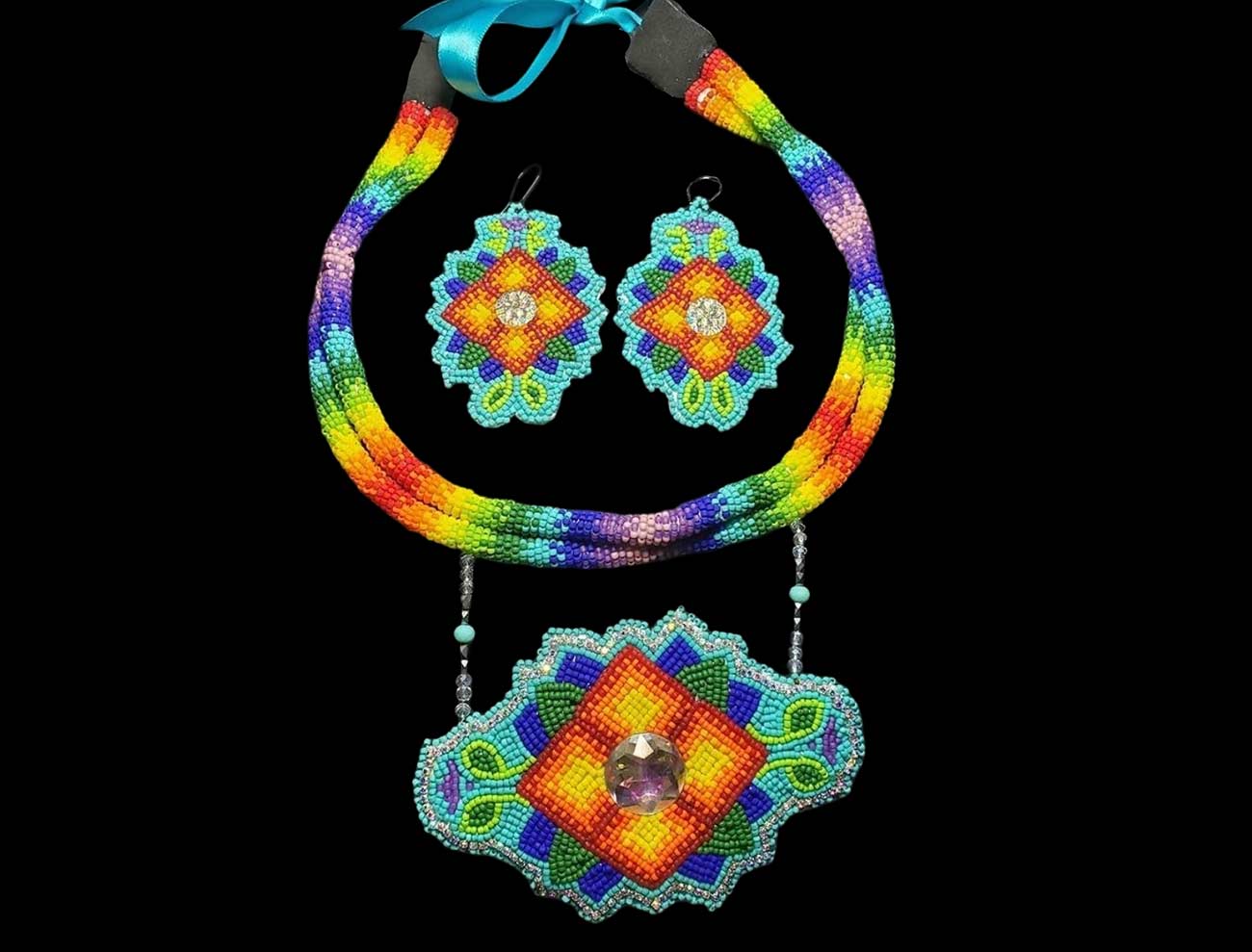 A set of rainbow beaded necklace and earrings.