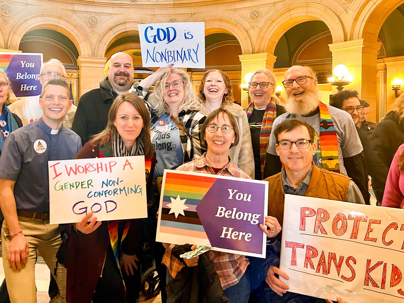 Members of the Prism Organization at the capital holding signs to protect trans rights.