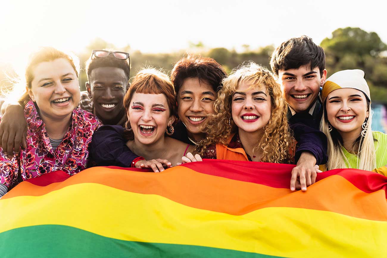 Diverse young friends celebrating gay pride festival - LGBTQ community concept.