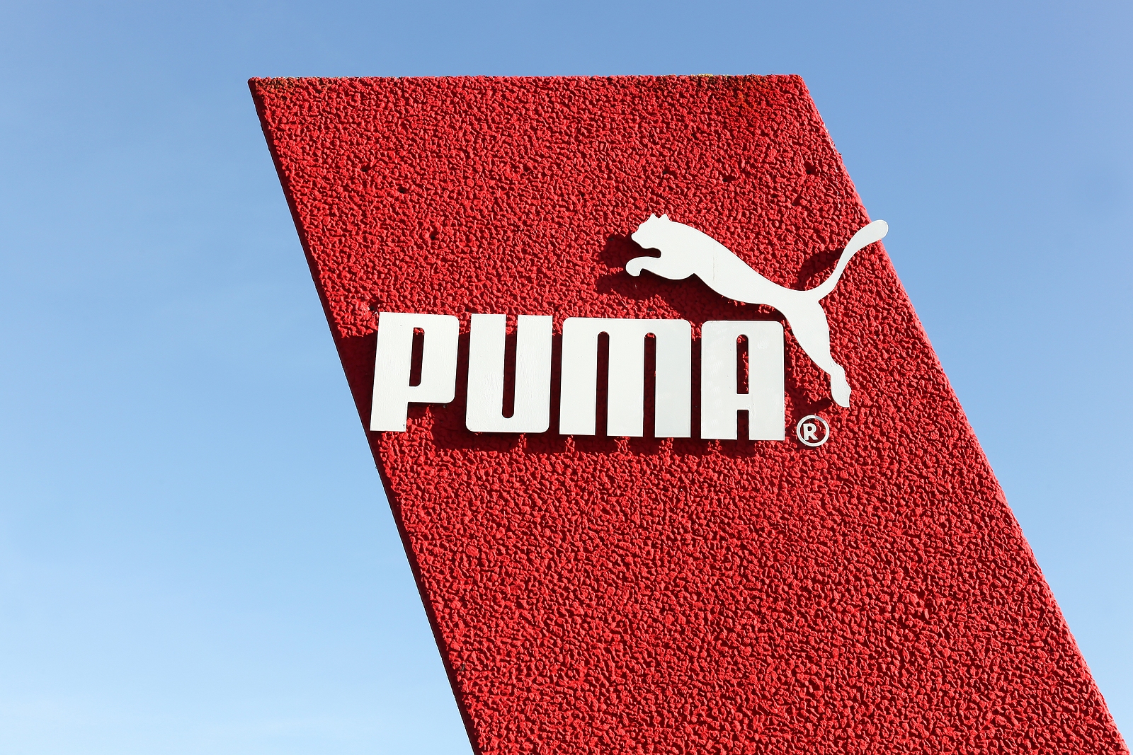Puma corporate logo on a red sign.