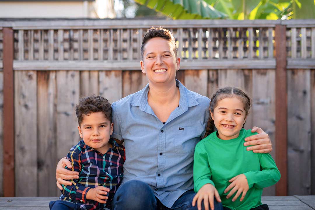 Marea Goodman sitting with her two children.