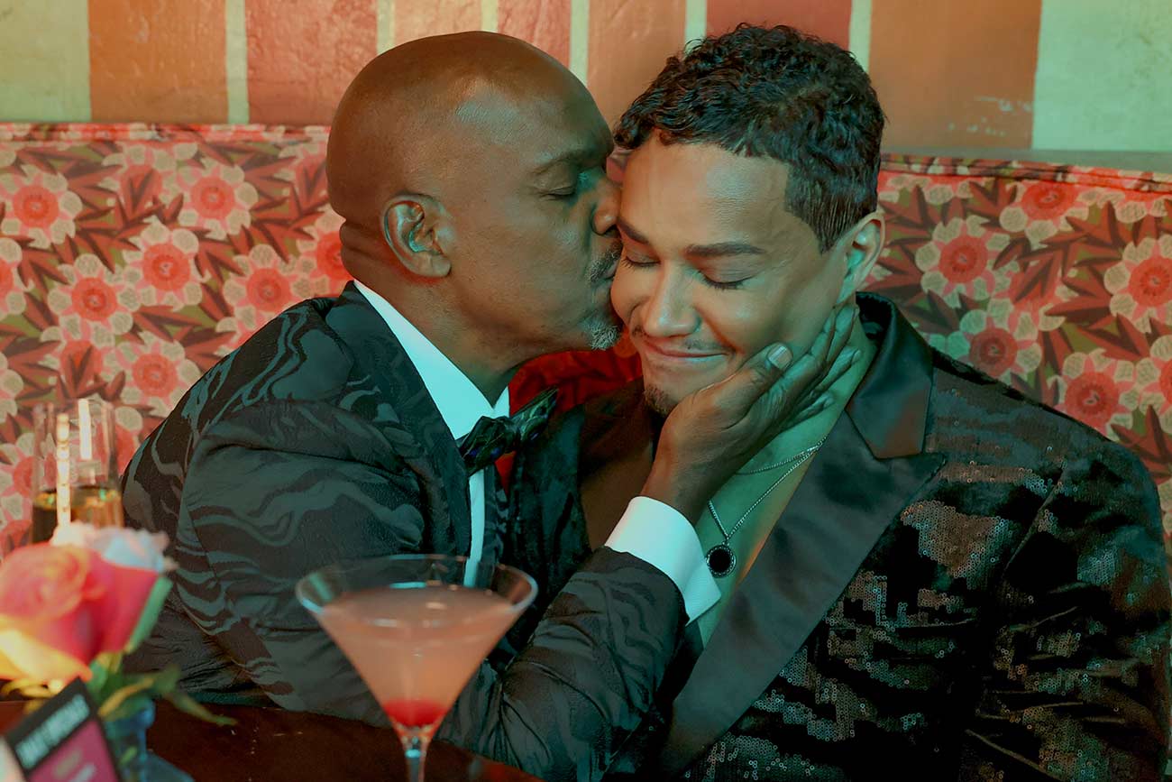 Noah's Arc actors sharing a kiss on the cheek.