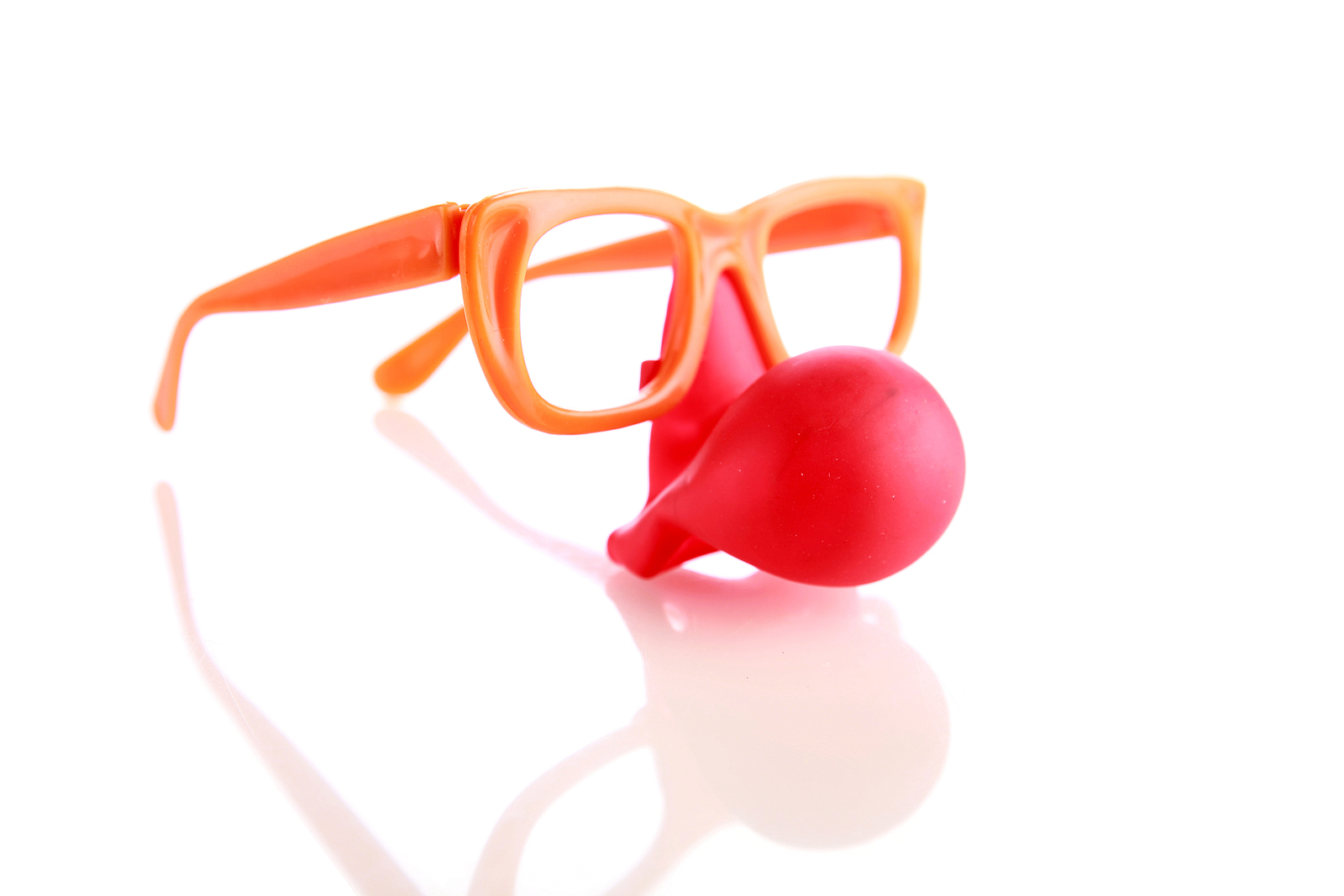 Funny orange fake glasses with a bright red clown nose.